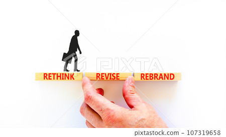Rethink revise rebrand symbol. Concept word Rethink Revise Rebrand on beautiful block. Beautiful white table white background. Business brand motivational rethink revise rebrand concept. Copy space. Rethink revise rebrand symbol. Concept word Rethink Revise Rebrand on beautiful block. Beautiful white table white background. Business brand motivational rethink revise rebrand concept. Copy space. 107319658