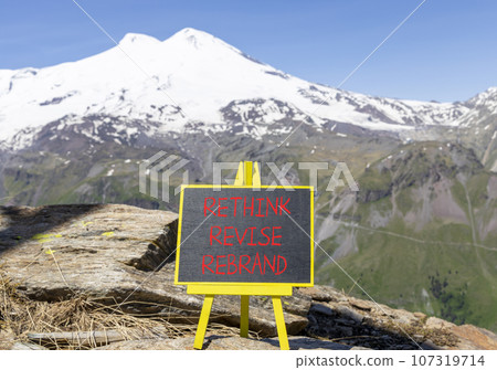 Rethink revise rebrand symbol. Concept word Rethink Revise Rebrand on beautiful blackboard. Beautiful mountain Elbrus background. Business brand motivational rethink revise rebrand concept. Copy space 107319714