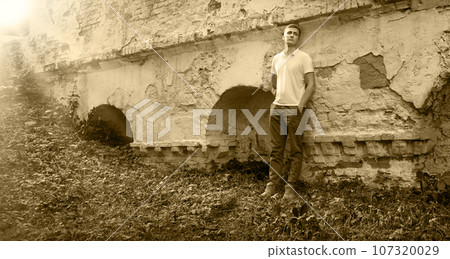 Young man staying at the wall 107320029