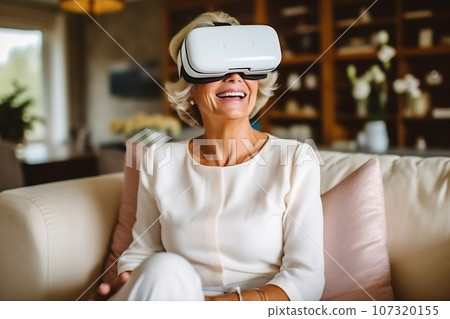 Senior mature female having fun with virtual reality glasses. Old woman using new headset goggles trends technology Senior mature female having fun with virtual reality glasses. Old woman using new headset goggles trends technology 107320155