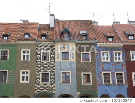 Old Market Square is a popular tourist attraction in Poznan, Poland. Beautiful houses on the east side, next to the old city hall 107320847