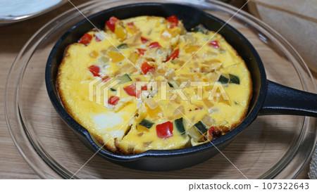 Omelette with vegetables made in skillet Omelette with vegetables made in skillet 107322643