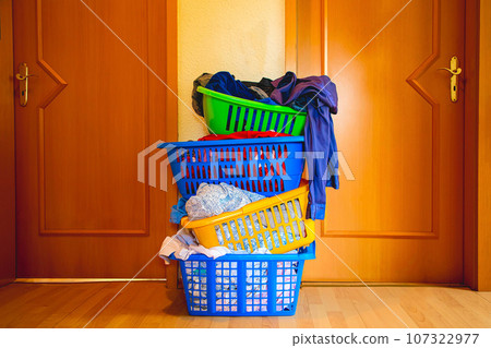 four multicolored baskets with washed laundry 107322977