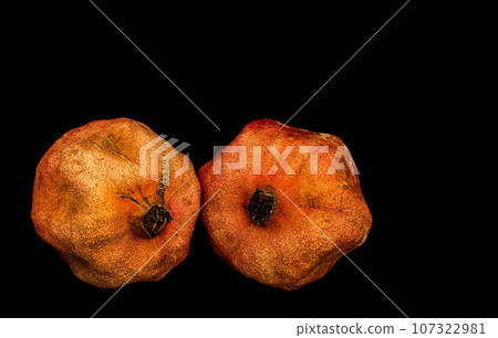 red pomegranate isolated on black background red pomegranate isolated on black background 107322981