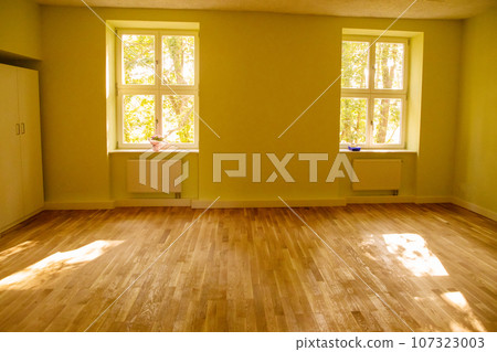 empty room in old apartment building with parquet floor and wooden windows empty room in old apartment building with parquet floor and wooden windows 107323003