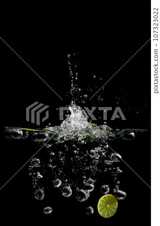 bright juicy fruits with splashes on black background. 107323022