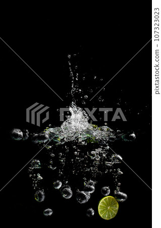 bright juicy fruits with splashes on black background. 107323023