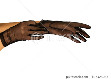 Female hands in black short guipure gloves 107323084