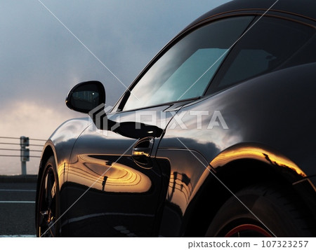 Black sports car bathing in the morning sun Black sports car bathing in the morning sun 107323257