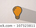 Abstract orange thinking light bulb on concrete wall background 107323811