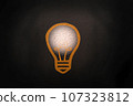 Abstract thinking light bulb on black concrete wall background 107323812