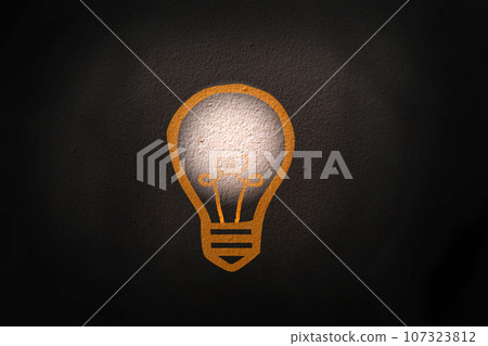 Abstract thinking light bulb on black concrete wall background 107323812