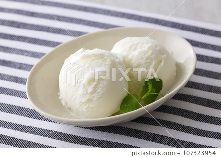 Milk ice cream made with milk on a plate Milk ice cream made with milk on a plate 107323954