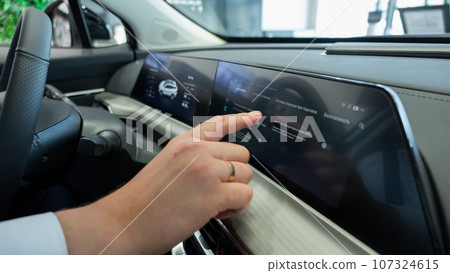 Close-up of a man's hands on the dashboard of a modern car. Close-up of a man's hands on the dashboard of a modern car. 107324615