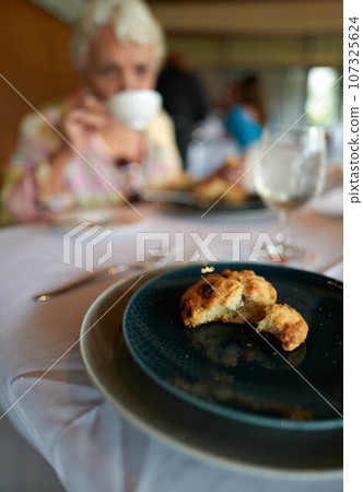 Senior woman having tea in the restaurant 107325624
