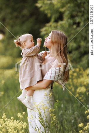 Young european woman in casual clothes with a small child 107326165