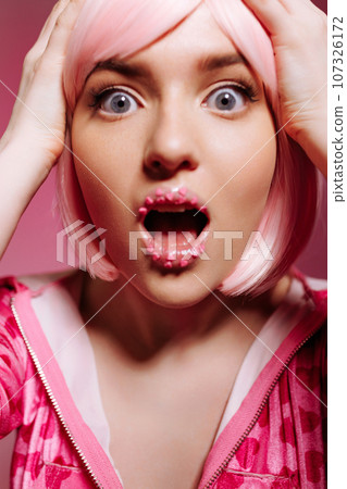 Glamor portrait of surprised shocked model with pink hair Glamor portrait of surprised shocked model with pink hair 107326172