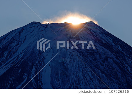 The morning sun rising over the summit of Mt. Fuji seen from Asagiri Plateau and Mt. Amegatake 107326216