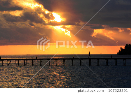 Sunset sea illuminated by rays of light Sunset sea illuminated by rays of light 107328291
