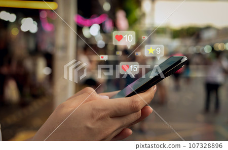 Hands holding smartphone with using a social media on mobile, typing message to communicate. Hands holding smartphone with using a social media on mobile, typing message to communicate. 107328896