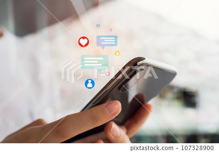 Hands holding smartphone with using a social media on mobile, typing message to communicate. Hands holding smartphone with using a social media on mobile, typing message to communicate. 107328900