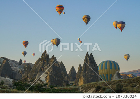 A popular holiday destination, a natural wonder. A holiday destination where you can travel in the sky with hot air balloons. Impressive view of hot air balloons and fairy chimneys. 107330024