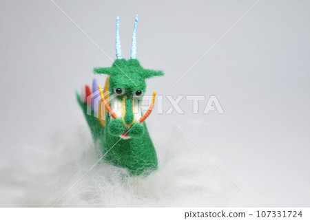 Standing on a green cloud made of needle felt 107331724