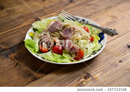 Marinated seafood salad with onions and olives 107333506