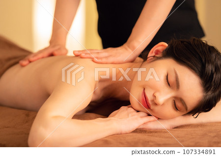 A middle-aged woman doing skin care at a beauty salon A middle-aged woman doing skin care at a beauty salon 107334891