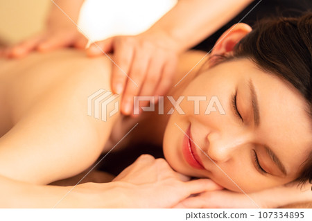 A middle-aged woman doing skin care at a beauty salon A middle-aged woman doing skin care at a beauty salon 107334895
