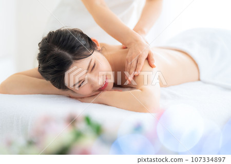 A middle-aged woman doing skin care at a beauty salon A middle-aged woman doing skin care at a beauty salon 107334897