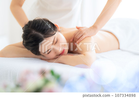 A middle-aged woman doing skin care at a beauty salon A middle-aged woman doing skin care at a beauty salon 107334898