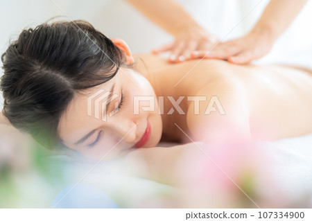 A middle-aged woman doing skin care at a beauty salon A middle-aged woman doing skin care at a beauty salon 107334900