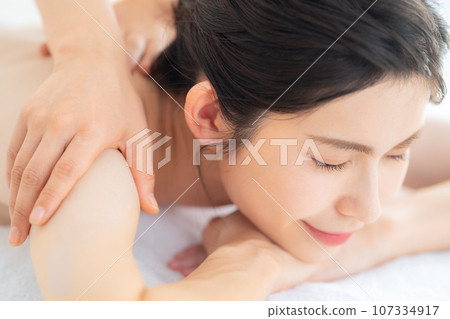 A middle-aged woman doing skin care at a beauty salon A middle-aged woman doing skin care at a beauty salon 107334917