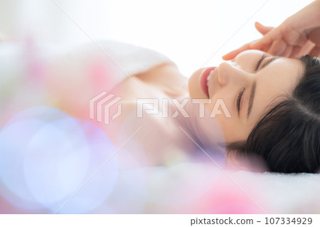 A middle-aged woman doing skin care at a beauty salon 107334929