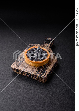 Delicious fresh sweet round tart with ripe blueberries and cream Delicious fresh sweet round tart with ripe blueberries and cream 107335786