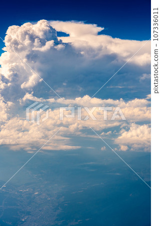 Cumulonimbus clouds aerial photography airplane sunset evening afternoon airplane flight travel tourism inbound 107336011