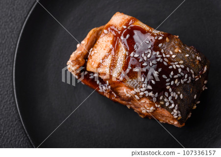 Delicious grilled salmon fillet with salt, spices, herbs and sauce Delicious grilled salmon fillet with salt, spices, herbs and sauce 107336157