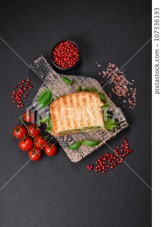 Delicious crispy sandwich with toast, salmon, avocado, tomatoes, salt, spices and herbs Delicious crispy sandwich with toast, salmon, avocado, tomatoes, salt, spices and herbs 107336193