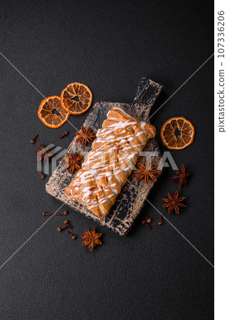 Delicious crispy braided bun with raisins inside and white icing outside Delicious crispy braided bun with raisins inside and white icing outside 107336206