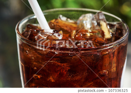 A glass of iced soda on the table 107336325