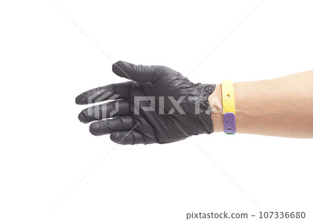 doctor's hand in black surgical medical gloves holds 107336680