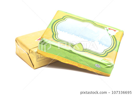 Sticks of wrapped butter isolated on white background 107336695