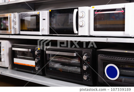 Image of assortment of a kitchen microwave at household appliances store 107339189