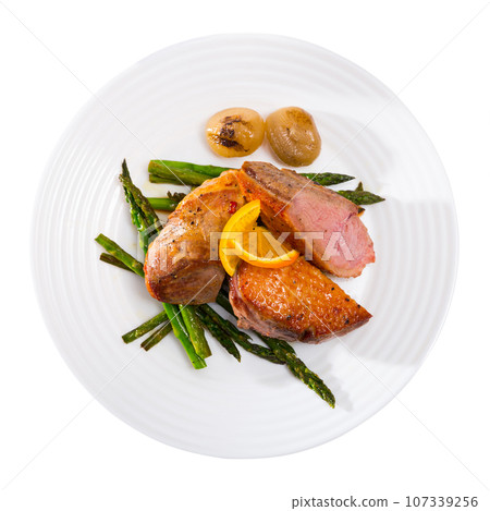 Top view of roasted duck breast with baked onions, asparagus Top view of roasted duck breast with baked onions, asparagus 107339256