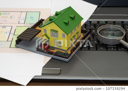 Floor plan and house model on a computer Floor plan and house model on a computer 107339294