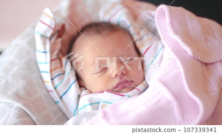 baby sleeping sun newborn close-up lifestyle. newborn a baby sleeping lying in bed looking at the camera close-up. motherhood family kid dream concept. newborn sleeping close eyes portrait baby sleeping sun newborn close-up lifestyle. newborn a baby sleeping lying in bed looking at the camera close-up. motherhood family kid dream concept. newborn sleeping close eyes portrait 107339341