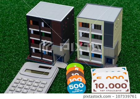 Studio apartment model, money and calculator 107339761
