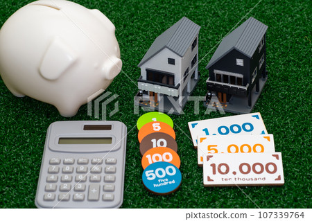 Image of a three-story house model and savings Image of a three-story house model and savings 107339764