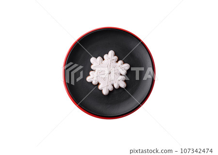 A beautiful Christmas composition consisting of ceramic plates, gingerbread and other elements A beautiful Christmas composition consisting of ceramic plates, gingerbread and other elements 107342474